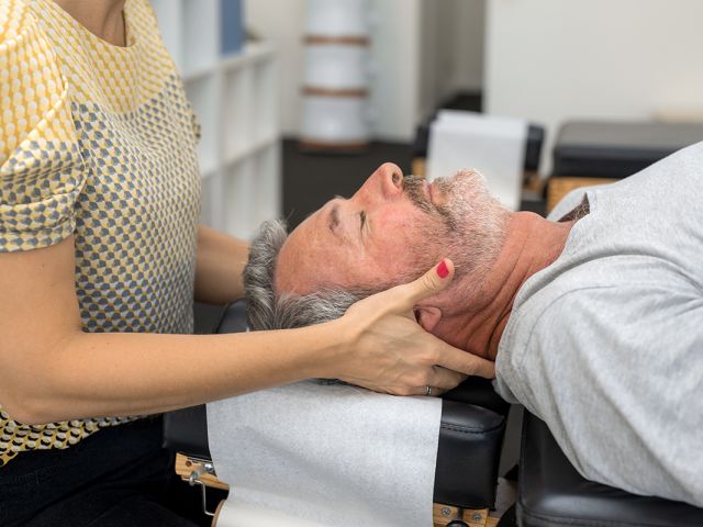 Senior man having chiropractic adjustment.