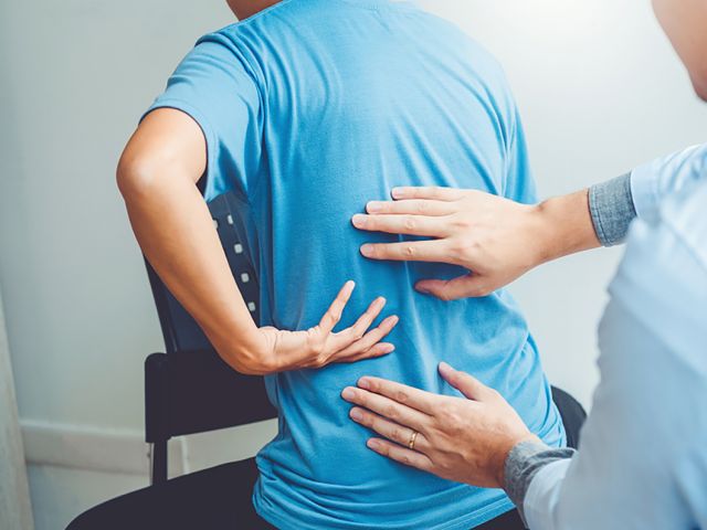 Doctor consulting with patient Back problems Physical therapy co